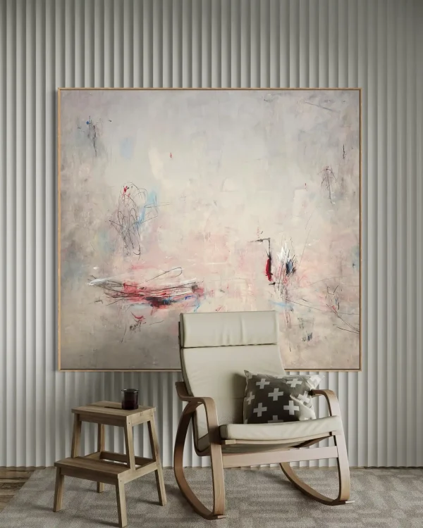 Large scale original PEZ artwork styled on a minimalist living room wall above a modern white accent chair and round stone coffee table for luxury interior inspiration.